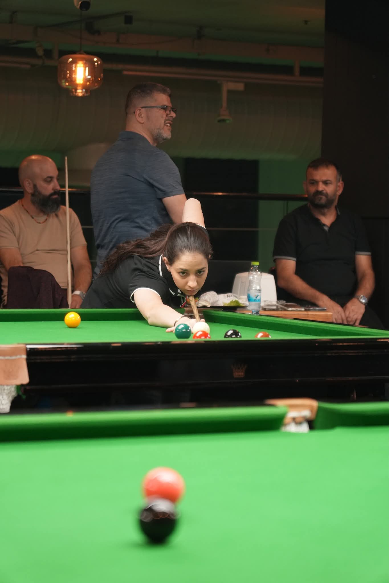 Karin Polonski cueing a shot at the snooker table